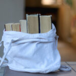 Fall in Love with Your Local Library, cloth tote bag filled with books