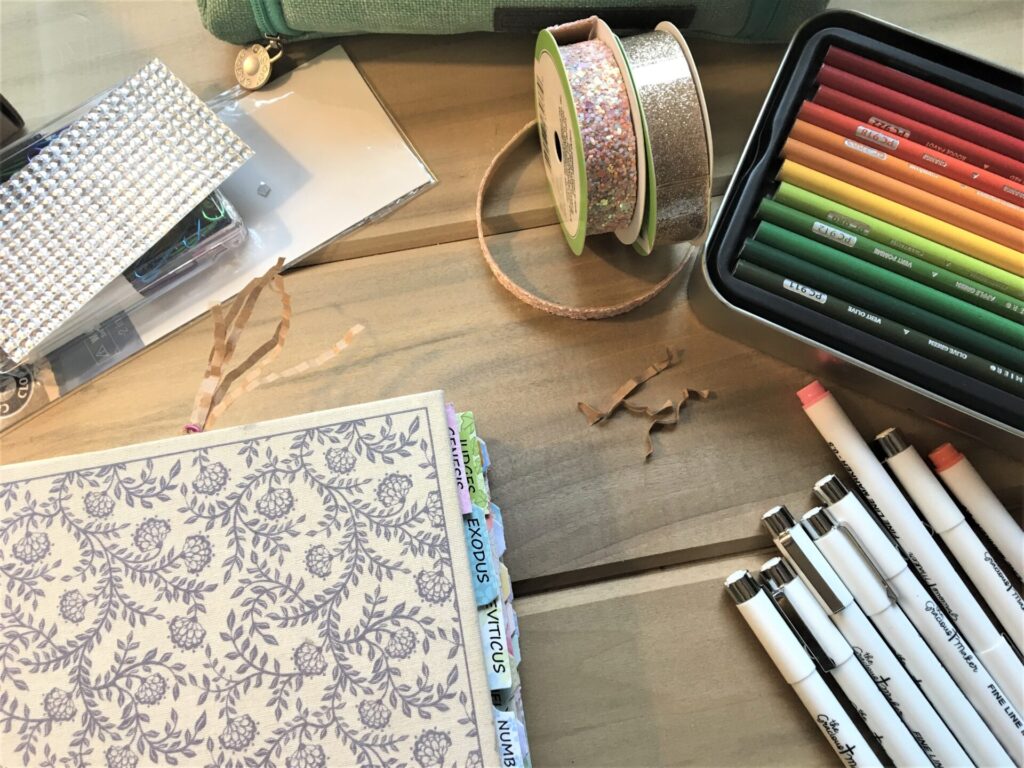 Creative Journaling Bible laying on surface with colored pencils and craft supplies